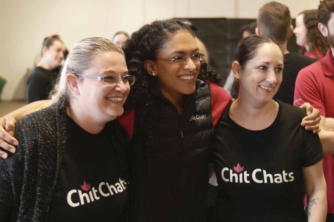 Three Chit Chats employees in company shirts
